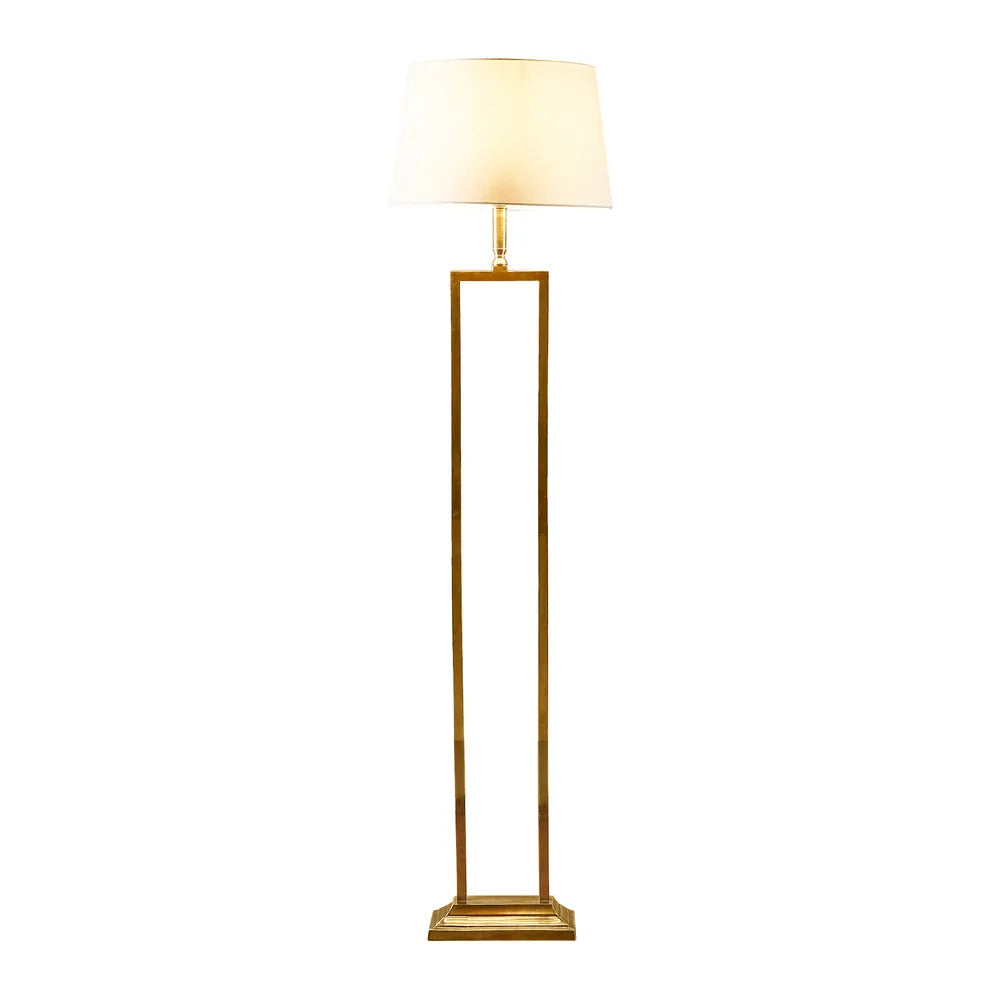 Elegant modern floor lamp with a gold-finished open rectangular frame and a classic off-white fabric lampshade. A stylish lighting piece for contemporary and luxury interiors.